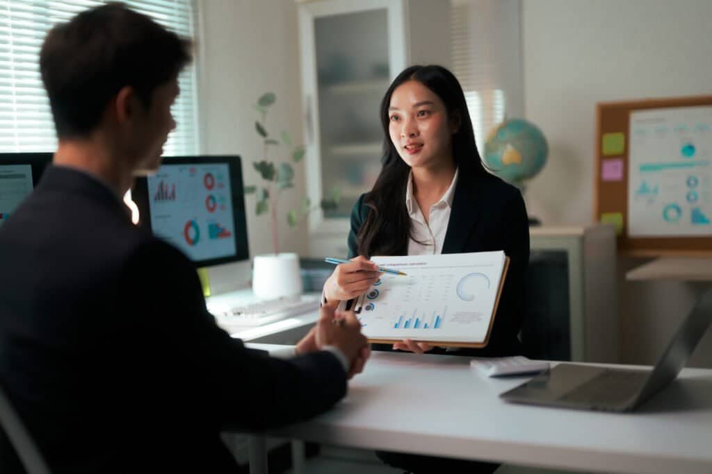 Businesswoman presenting financial data during a corporate meeting